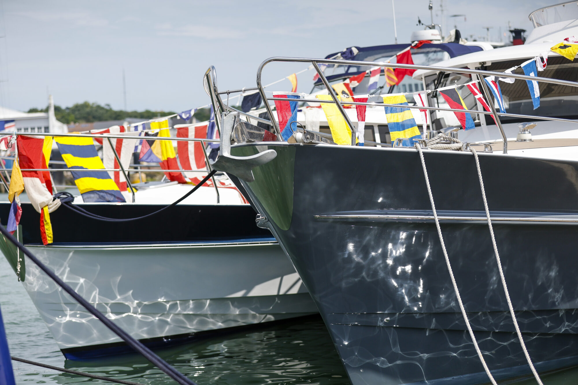 Bows of the classic Hardy hulls decorated with flags